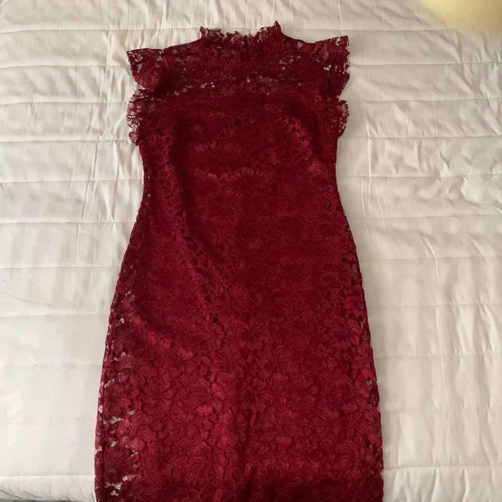 Fitted burgundy colored knee length dress has silk underlining